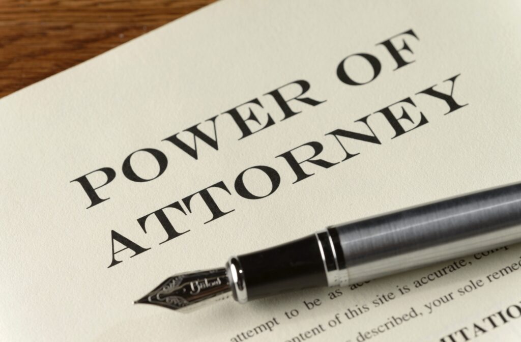 On the table lies a power of attorney document, with a pen positioned in the background.