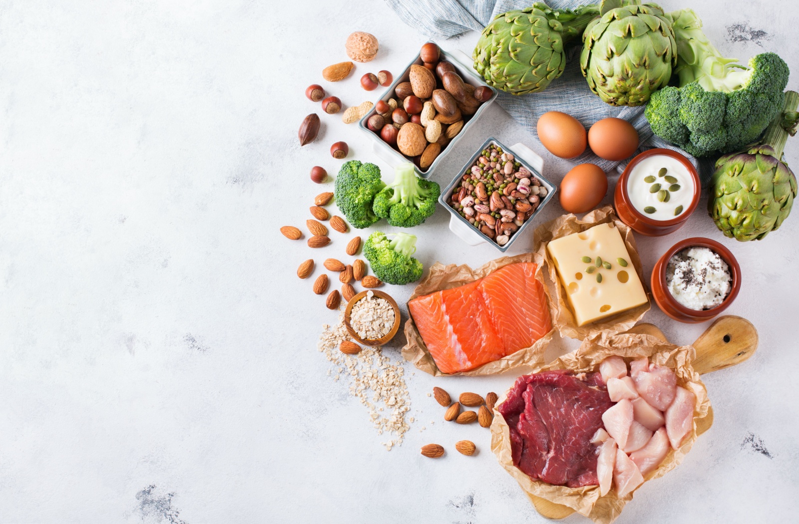 Different types of animal and plant-based protein sources on a countertop.