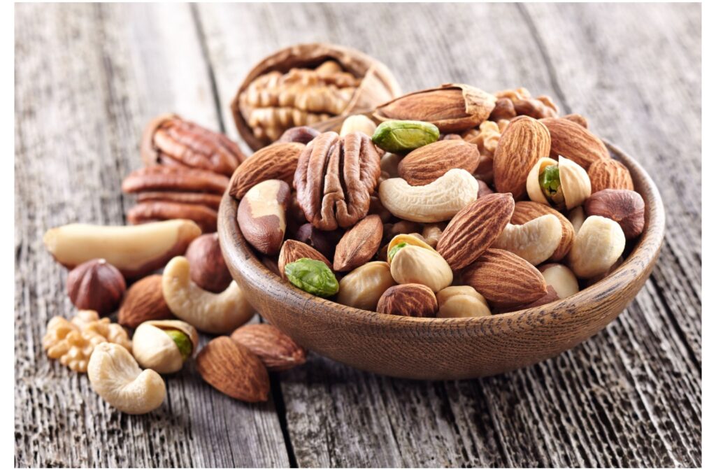 Different kinds of nuts on a table and in a bowl.