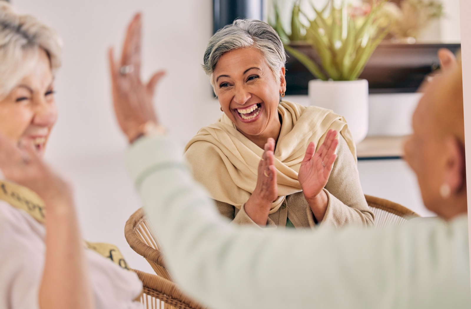 A group of seniors sharing laughs together in their independent living community.