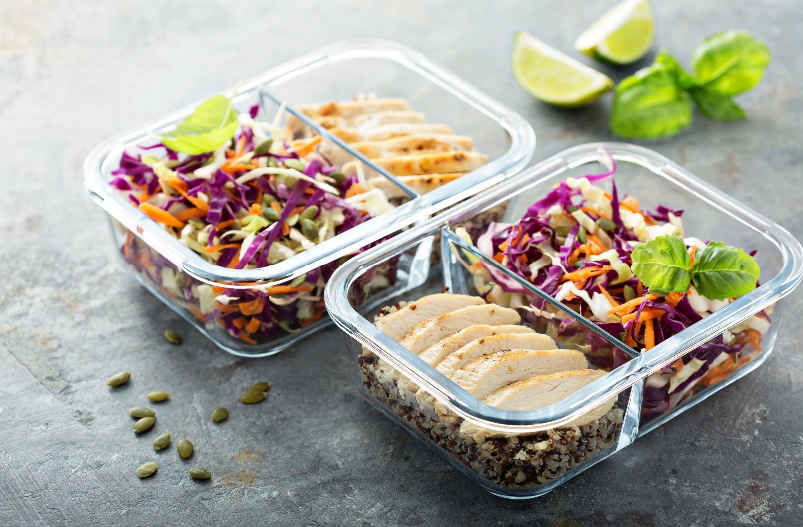 A picture of 2 delicious-looking and healthy meals divided between meal prep containers.